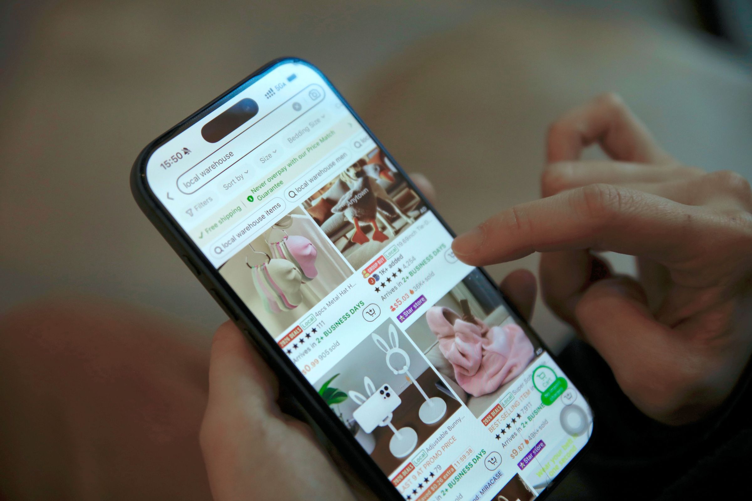 Person browsing products and prices on a phone