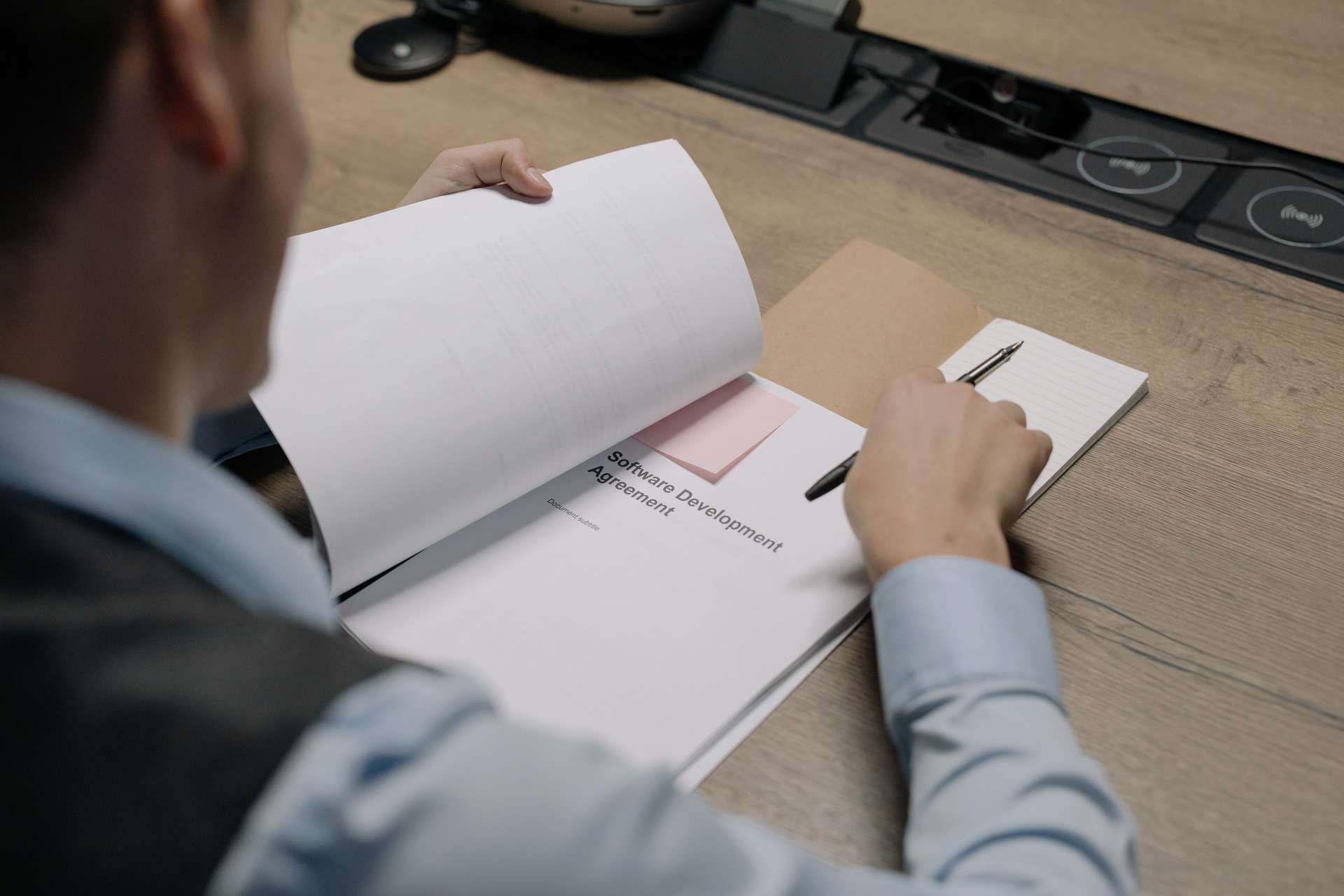 Manager reviewing a software requirements brief before requesting quotes