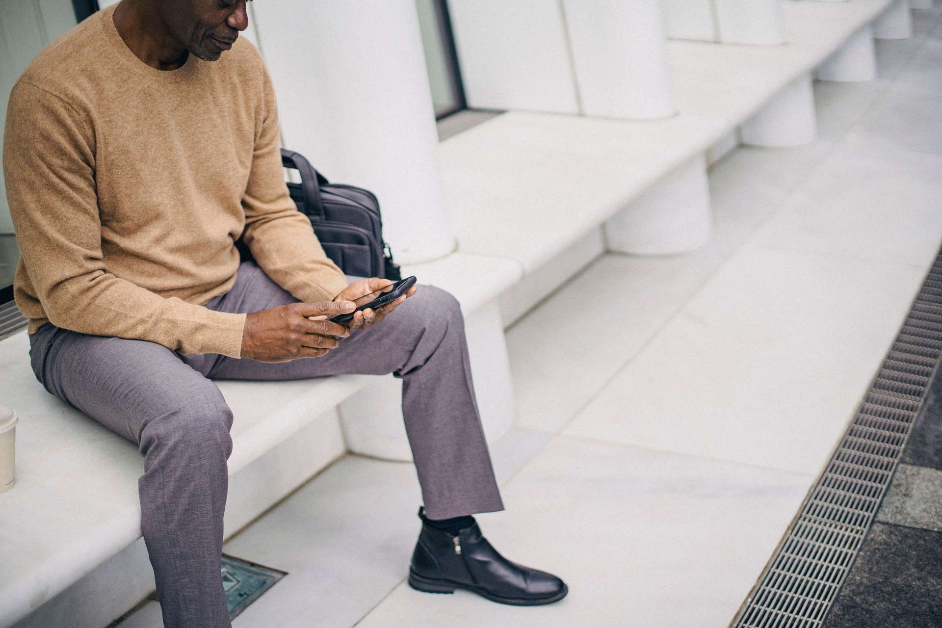 Business professional using a phone in a messaging journey connected to CRM