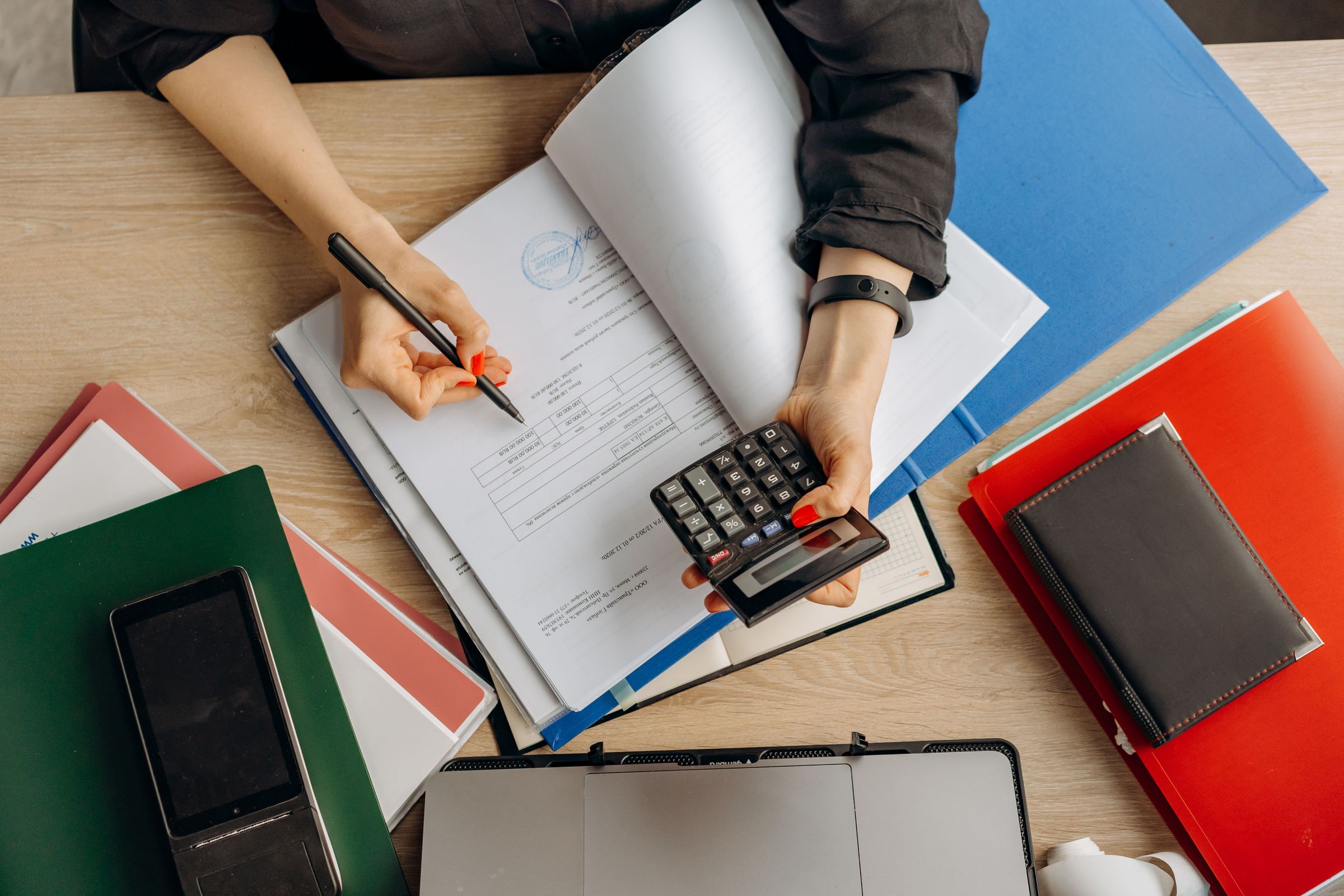 Reviewing paper accounting documents with a calculator