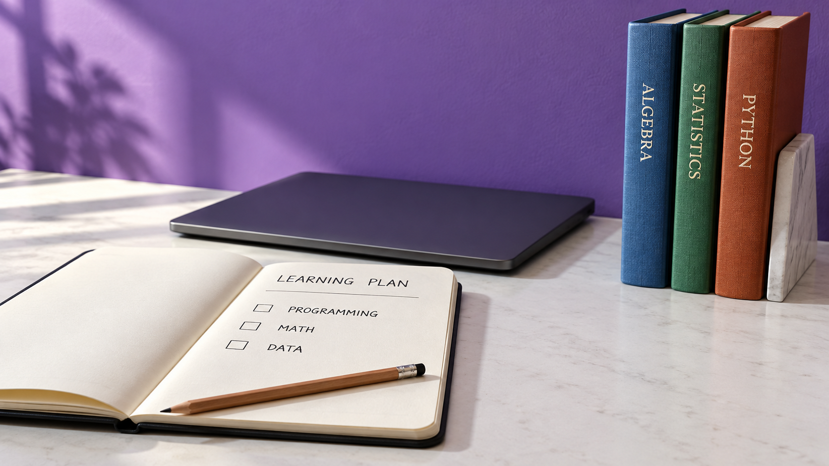 Blank learning plan beside algebra, statistics and Python books