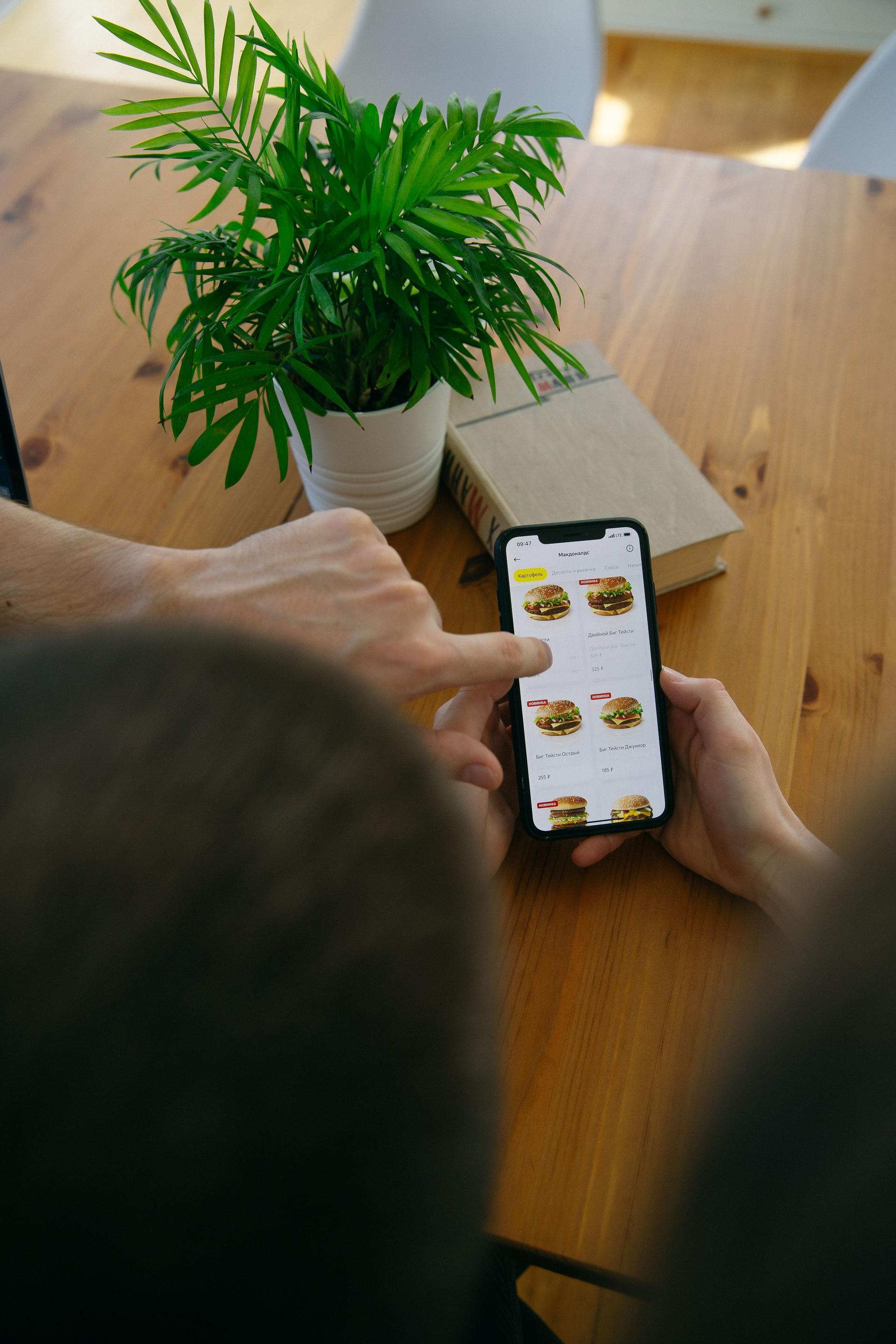 Diners in a Dubai restaurant using smartphones around a table to open a QR menu
