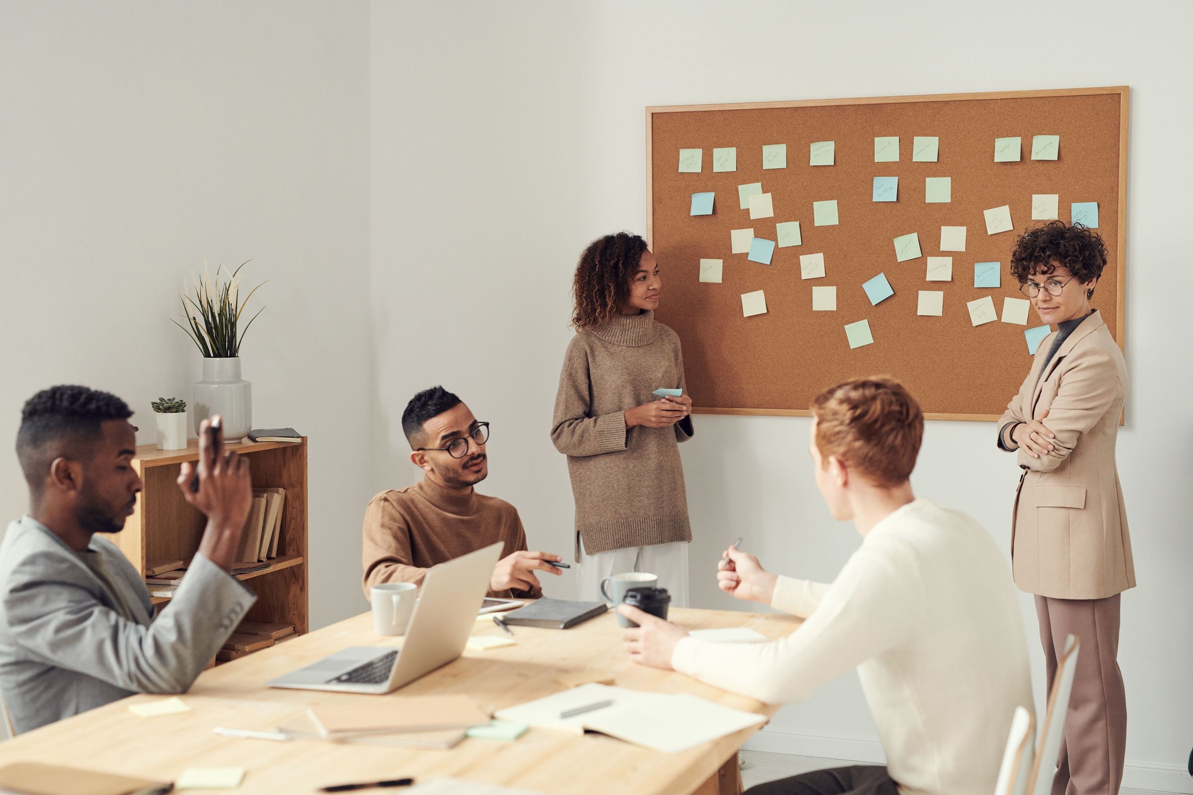 Team discussing ideas in front of a board of notes
