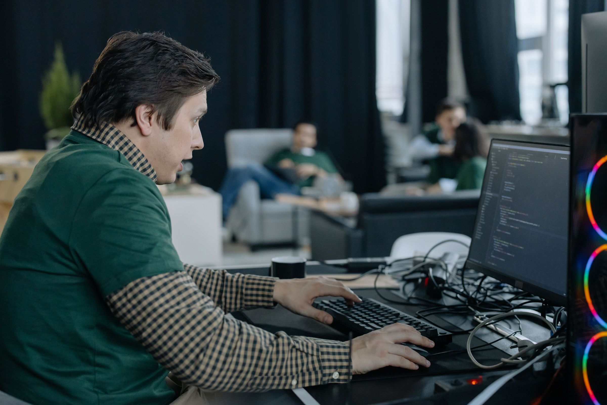 Programmer working with code visible on a computer screen