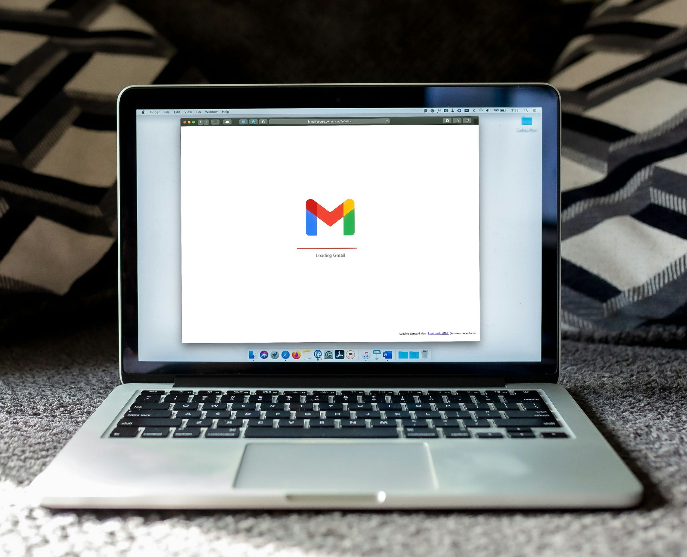A historical photograph of Gmail loading on a laptop