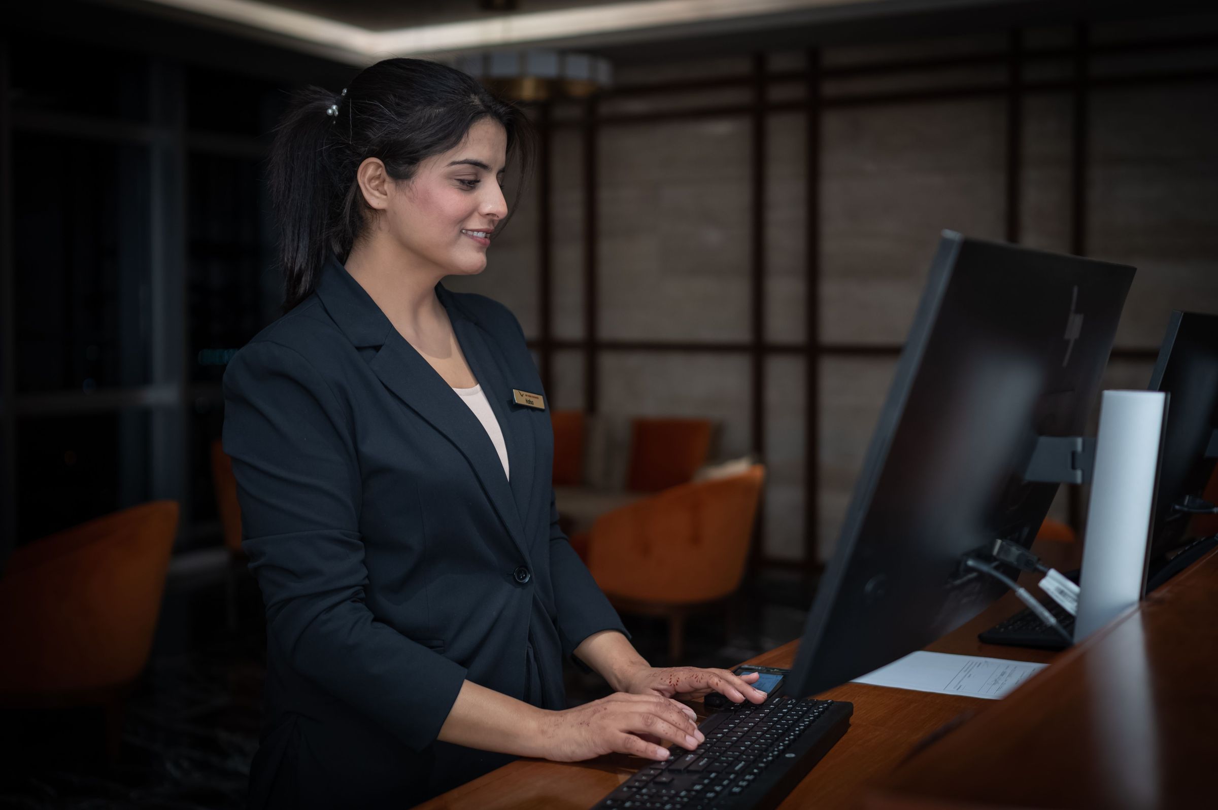 Receptionist working on a computer in a hotel in Islamabad