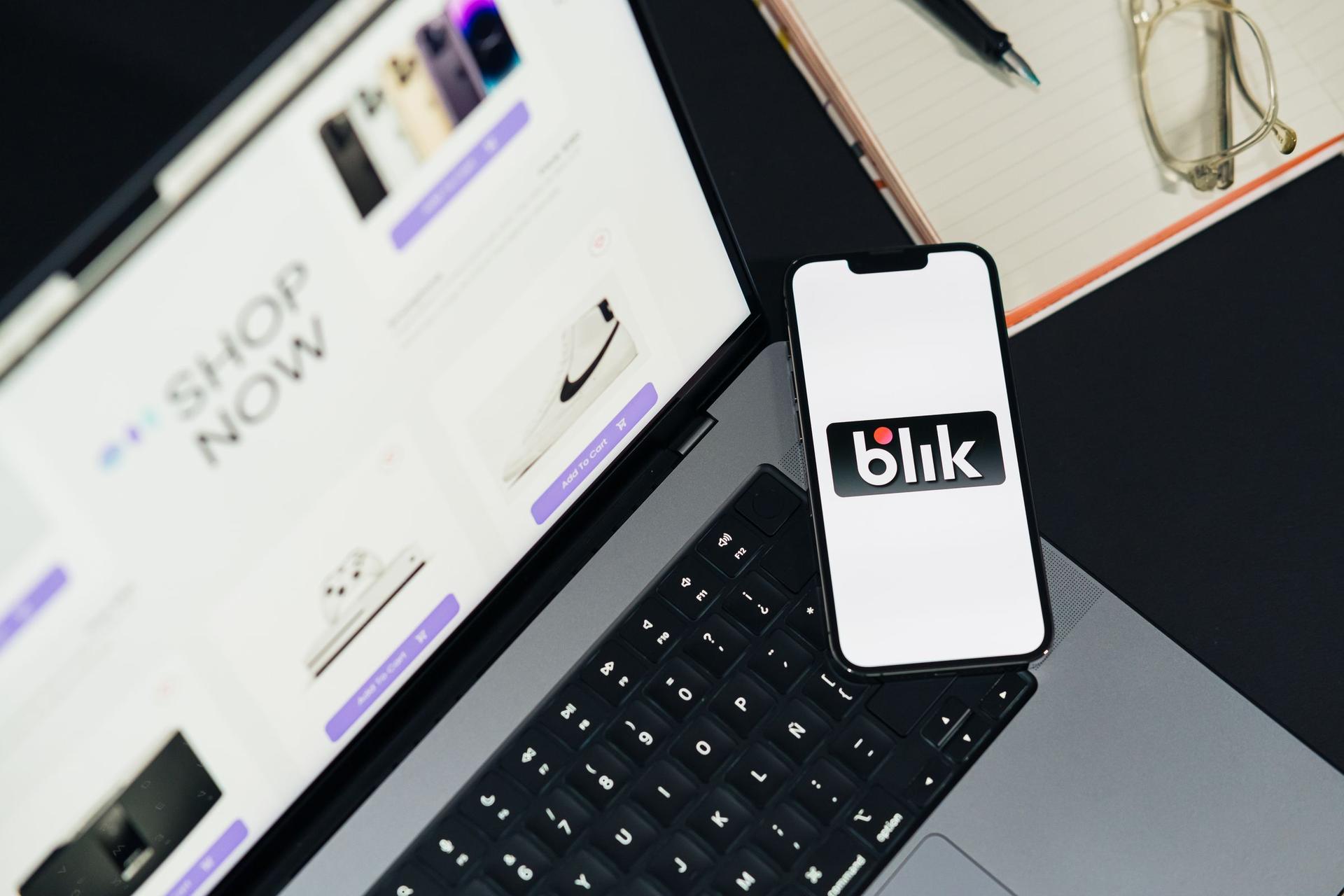 Store owner reviewing an ecommerce interface on a laptop and smartphone
