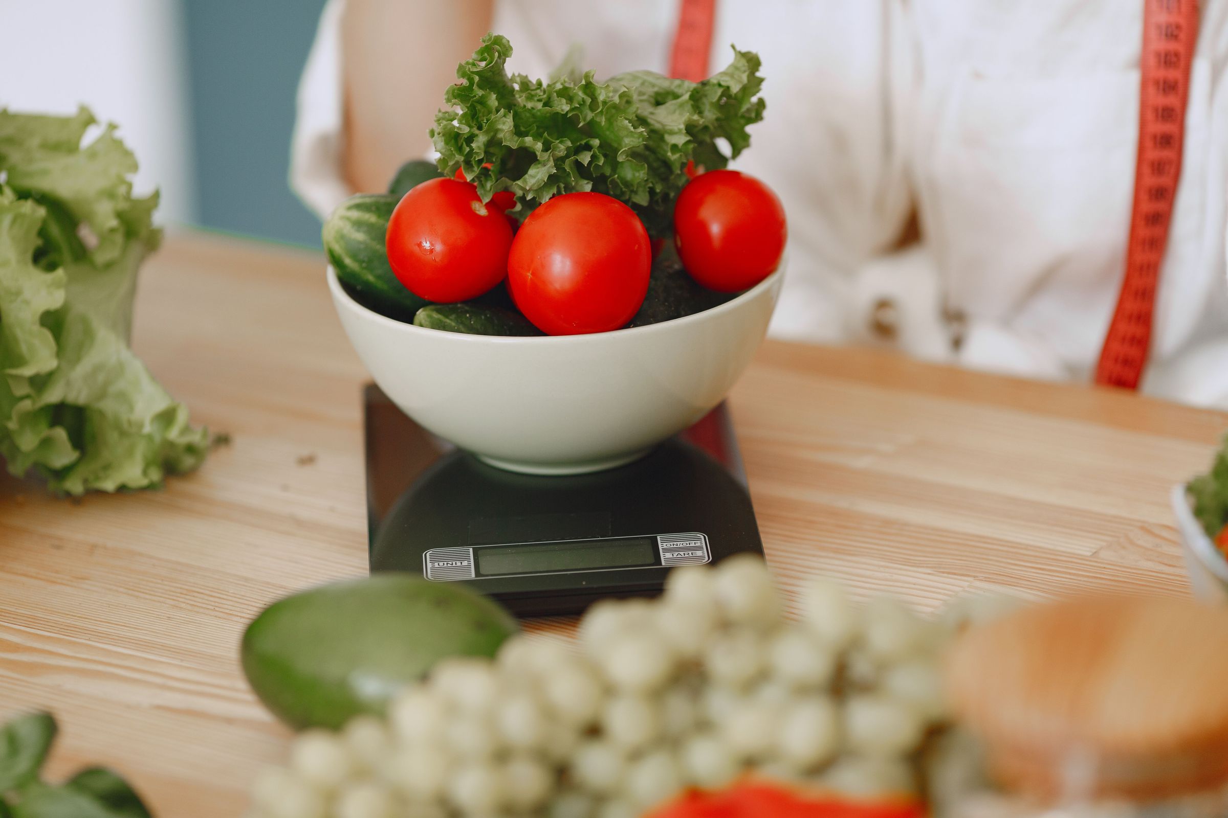 Vegetables in a bowl on a kitchen scale without a documented weight reading