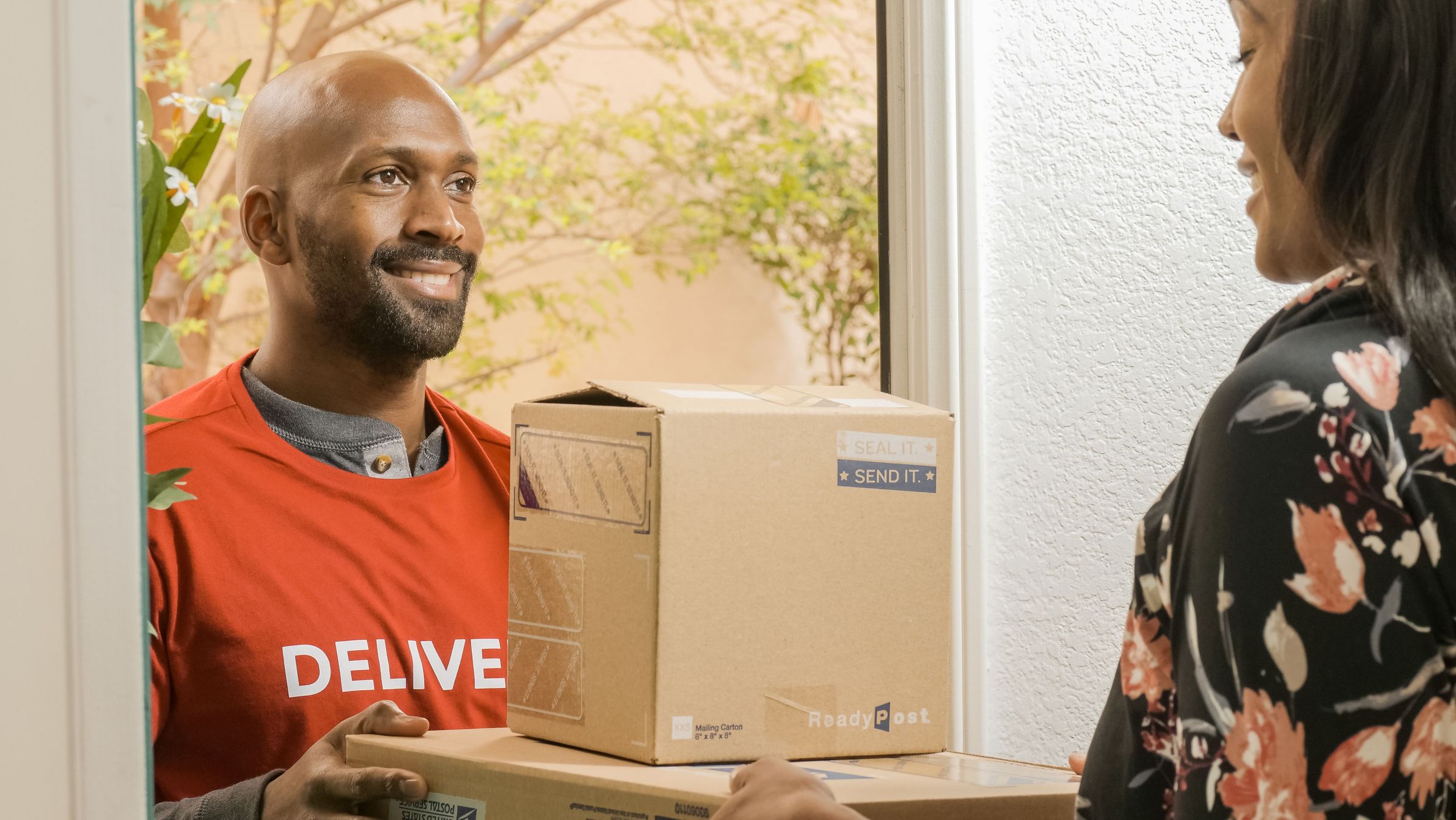 Handing parcels to a recipient at a home doorway