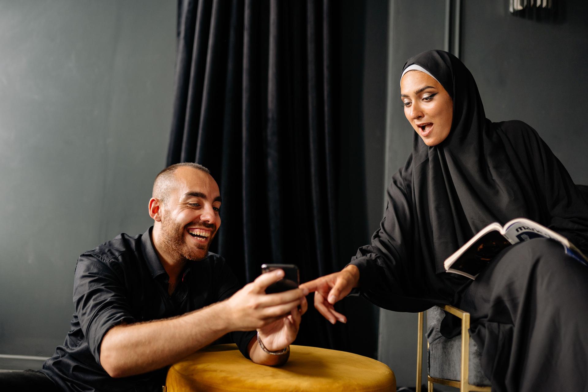 Two users testing an Arabic conversation on a smartphone
