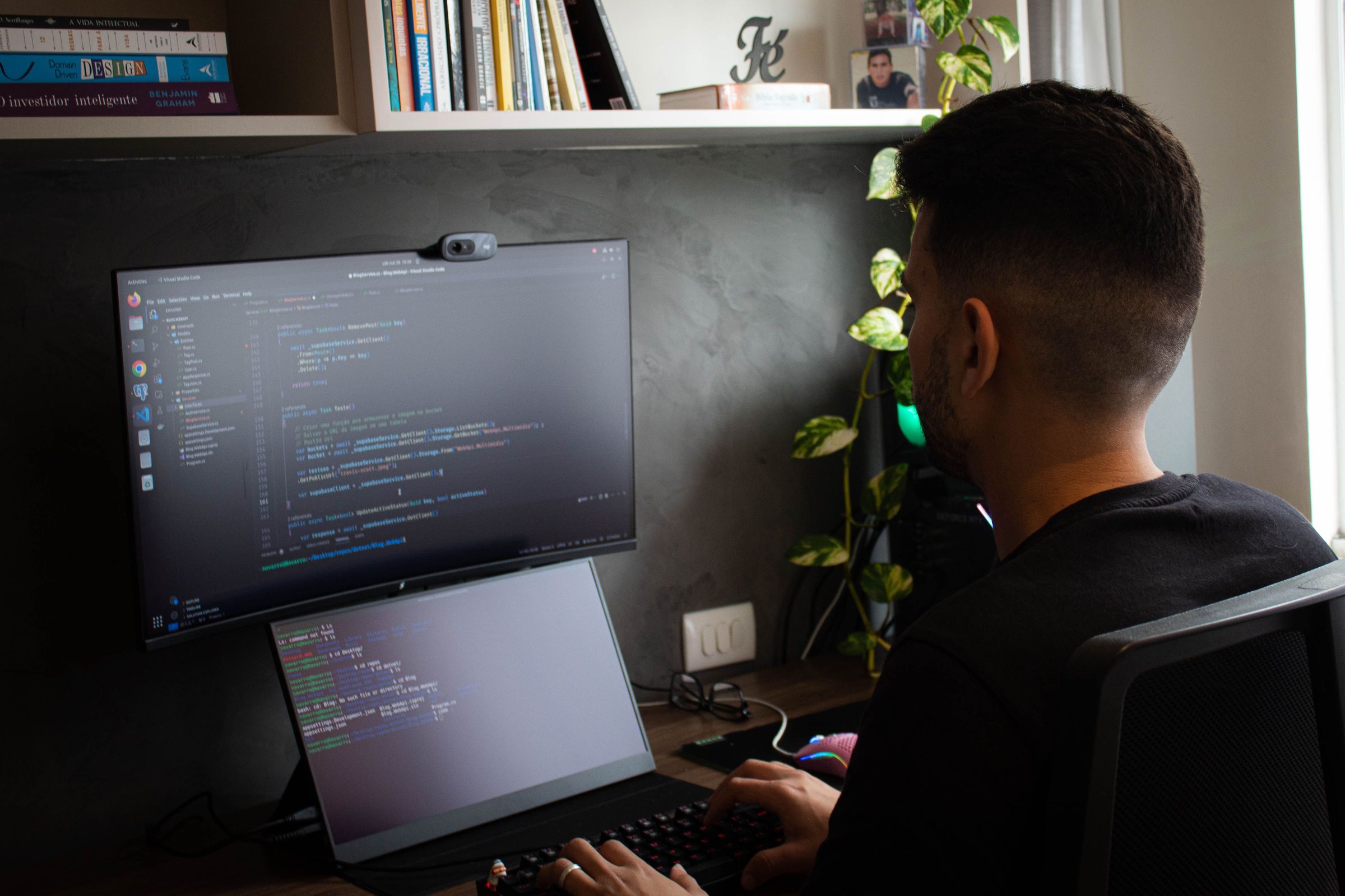 Person working at a computer in a programming workspace