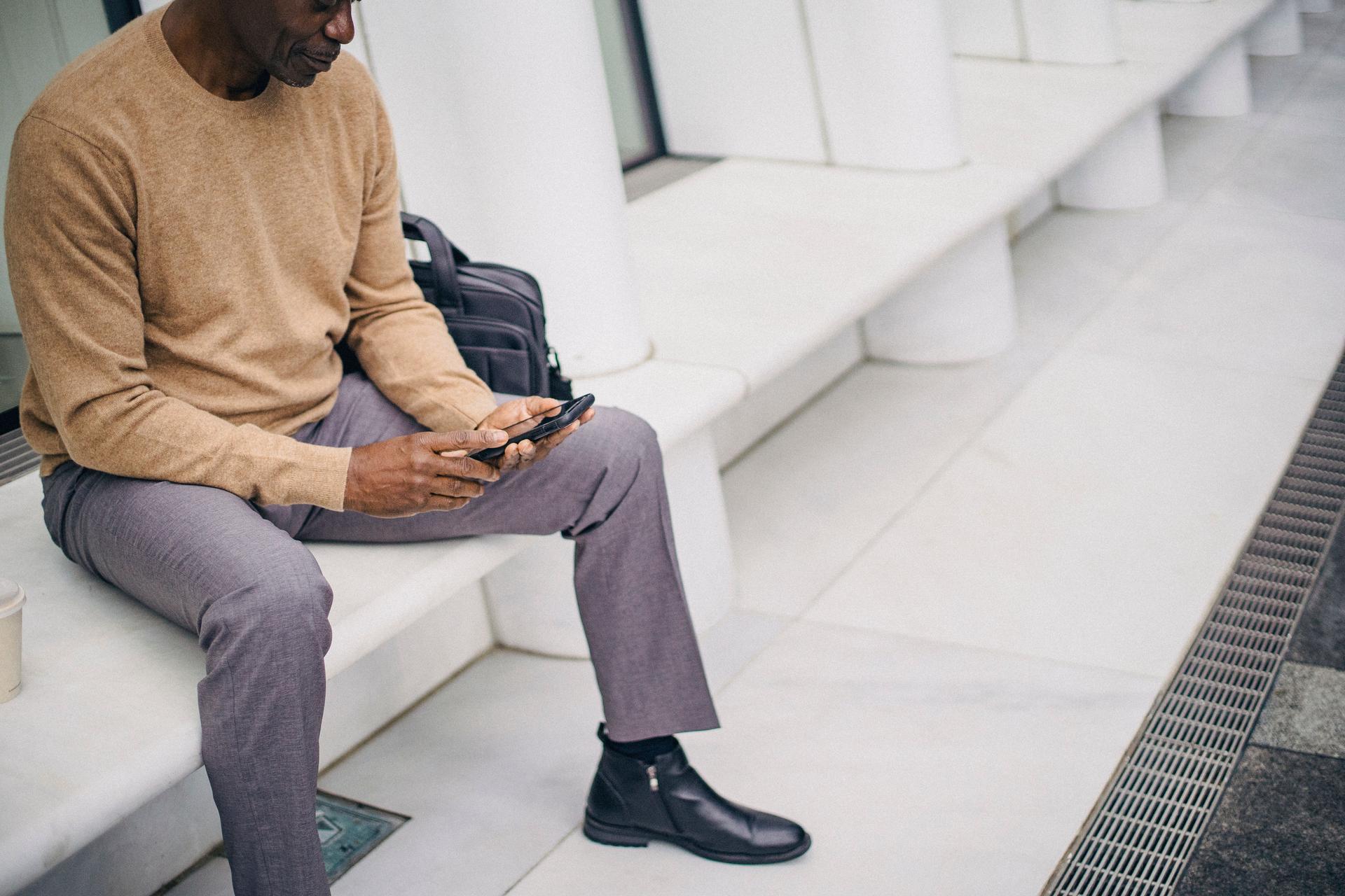 Business professional using a phone in a messaging journey connected to CRM