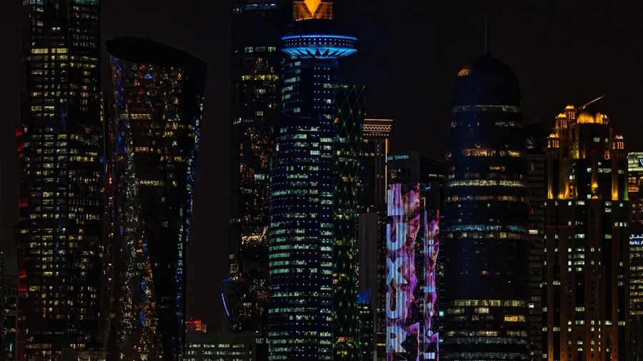 Doha skyline at night representing Gulf businesses budgeting for a chatbot