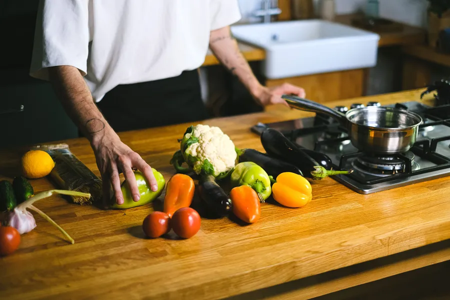 Person preparing vegetables on a kitchen counter