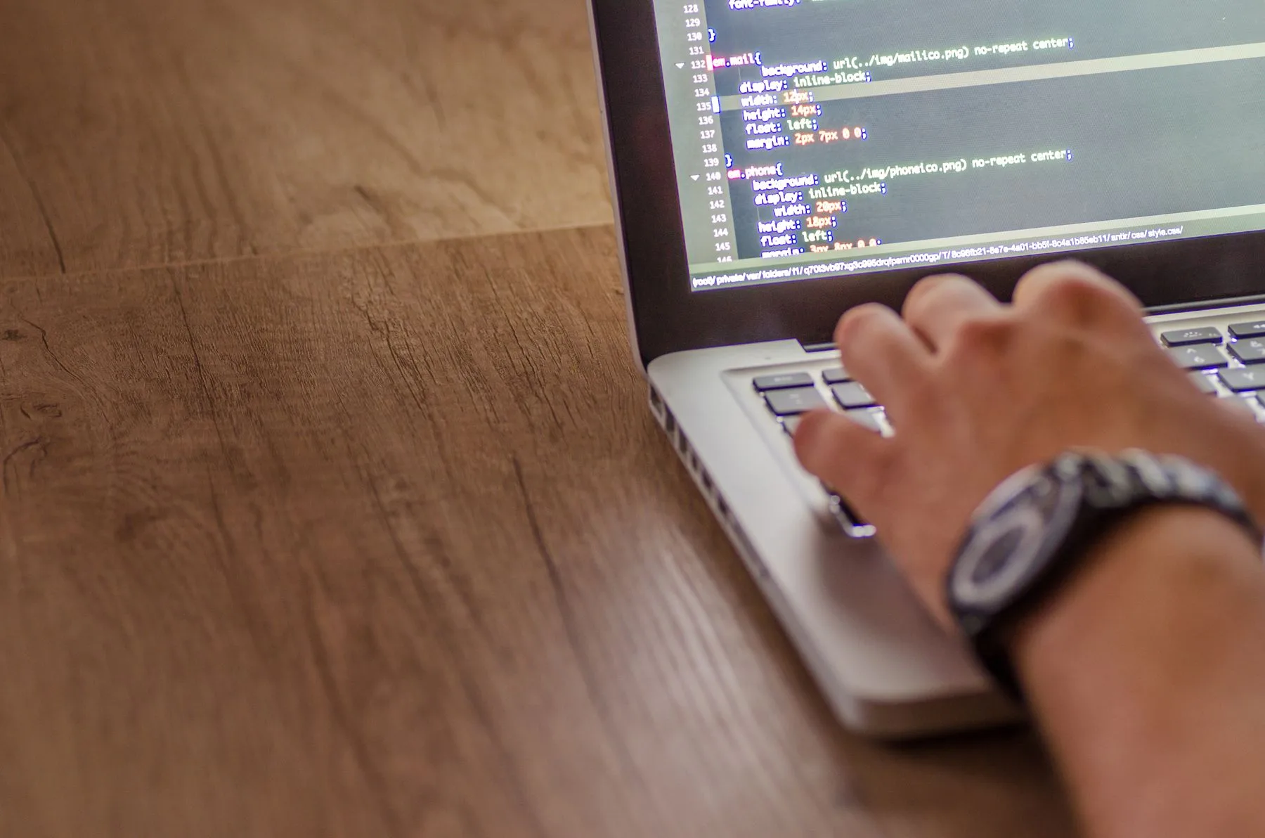 Developer reviewing a business website's code to close security gaps